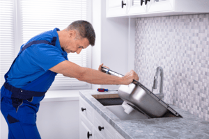 Man is cleaning kitchen sink