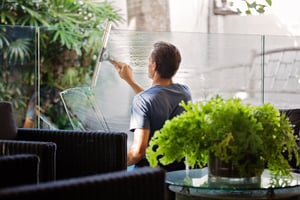 A man is cleaning a window